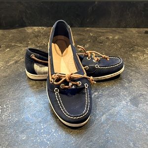Blue Suede Sperrys with blue and white fabric design on sides of shoe.